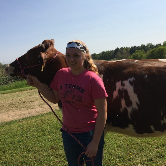This is a picture of my 4-H group member Calli and her cow Reba.